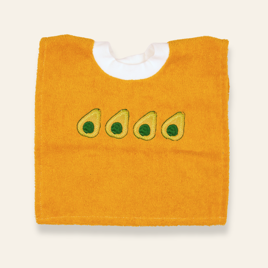 Soft yellow baby bib featuring embroidered avocados. Absorbent, playful, and perfect for everyday meals or gifting.