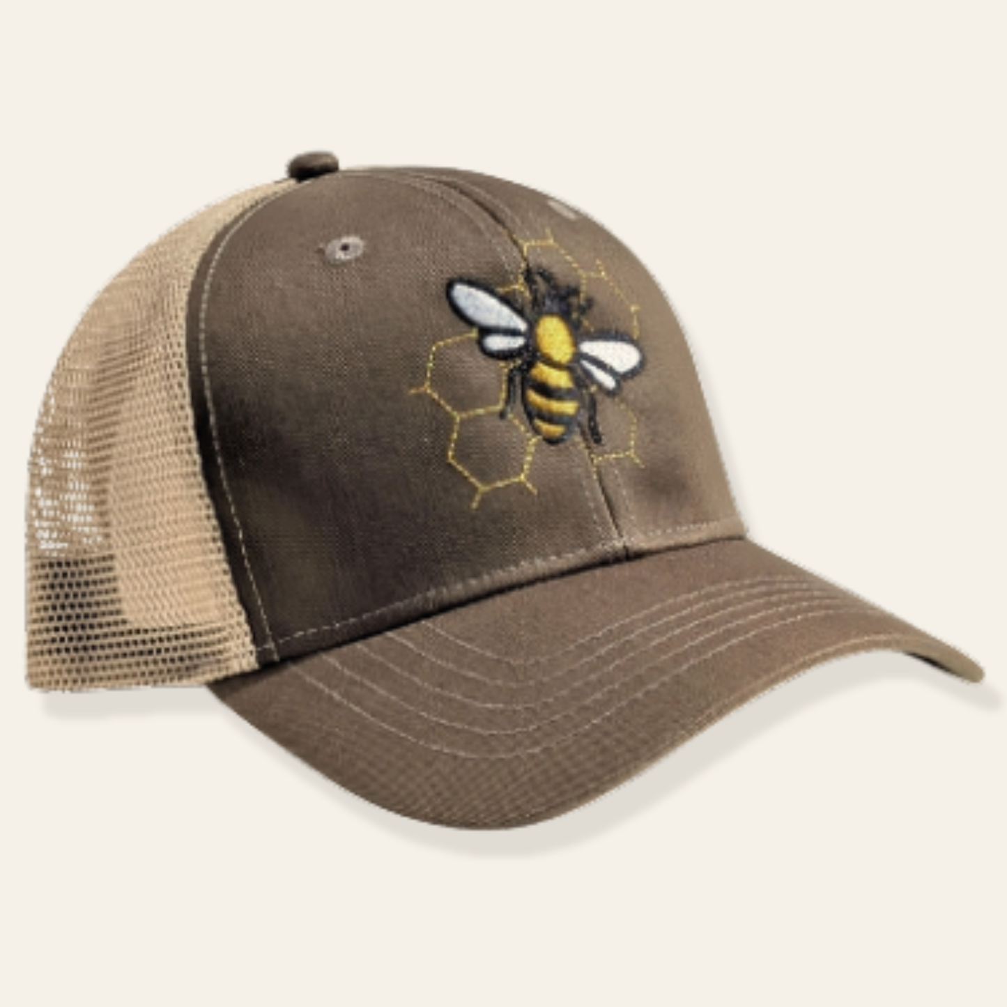 Olive and tan bee trucker cap with embroidered honeycomb design. Breathable mesh back and adjustable fit—perfect for everyday wear.