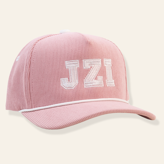 Pink corduroy baseball cap featuring white embroidered “JZI” lettering with contrast piping. Preppy, playful, and perfect for everyday wear or gifting.