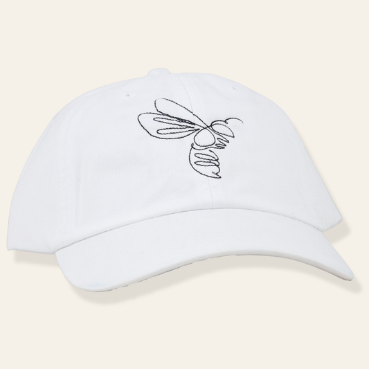 White embroidered cap featuring a minimalist line-art bee. Soft cotton, adjustable fit, and a timeless everyday accessory.