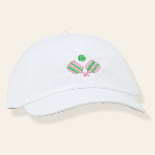 White embroidered pickleball cap with pink and green paddle design. Soft cotton, adjustable fit, and perfect for everyday wear or gifting.