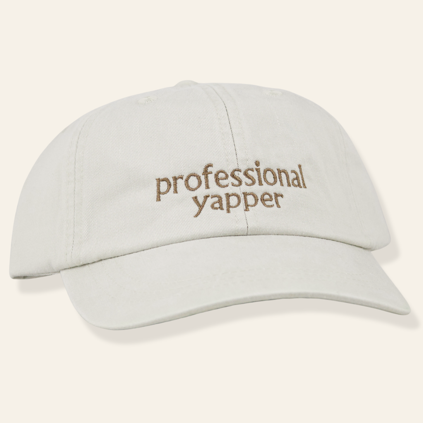 Neutral embroidered cap featuring “professional yapper.” Soft cotton, adjustable fit, and a funny everyday accessory perfect for gifting.