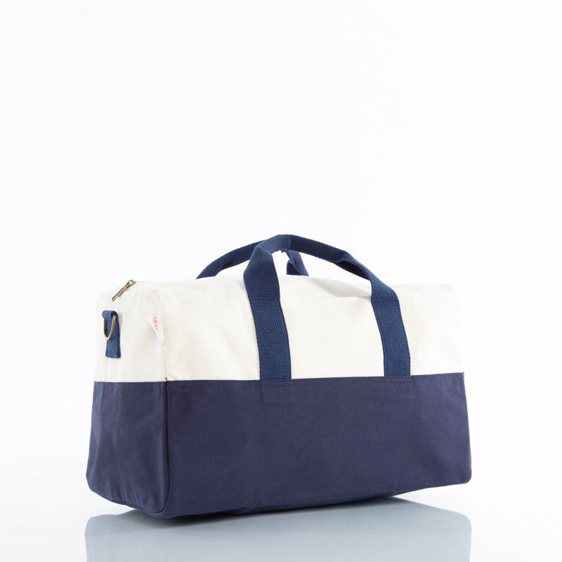 Child’s duffel bag in navy and beige canvas shown with both hand straps and a long shoulder strap.