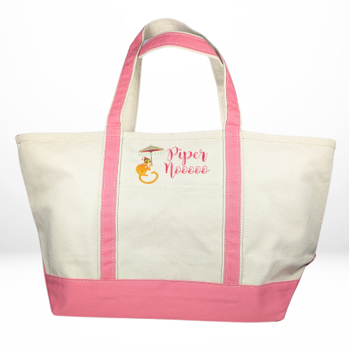 A cream canvas tote bag with coral pink straps and base, embroidered with a monkey holding a parasol and the text "Piper Noooo" in a decorative font.