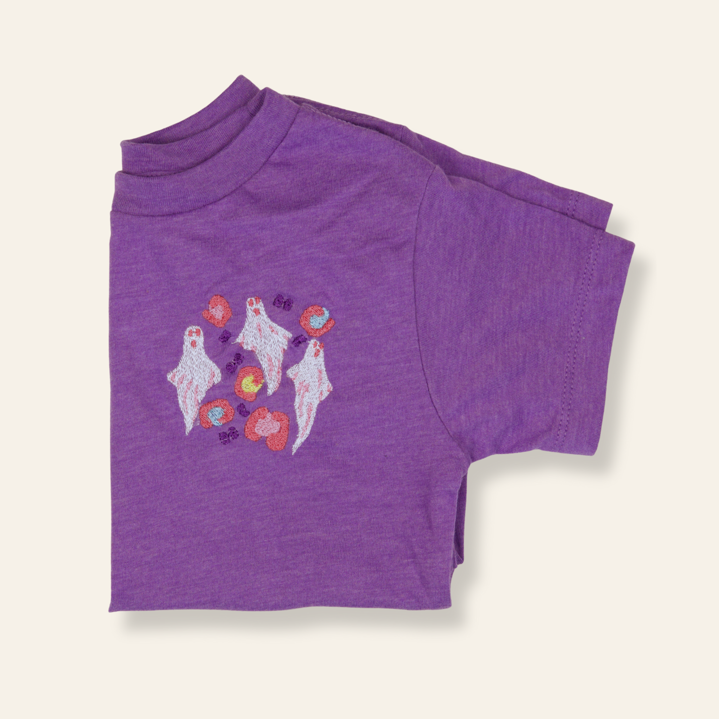 Purple kids t-shirt featuring embroidered ghosts and hearts. Playful, spooky-cute, and perfect for fall or everyday wear.