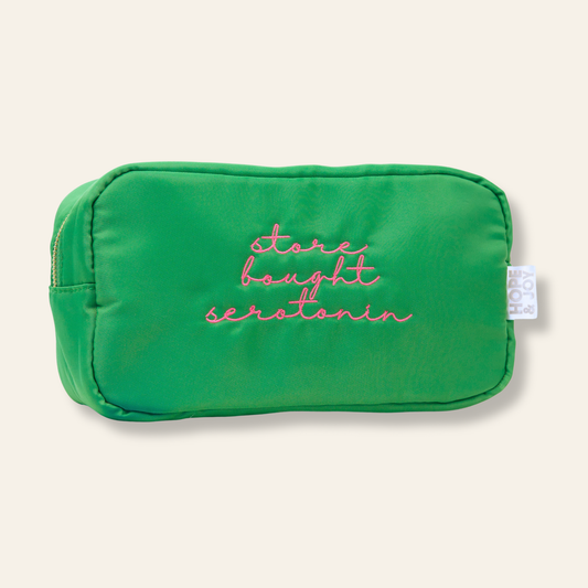 An embroidered medication pouch featuring “store bought serotonin.” A thoughtful, functional way to organize daily medications at home or while traveling.