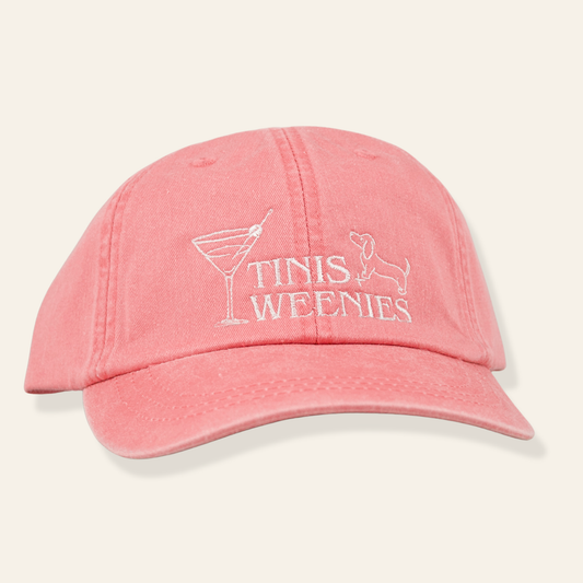 Washed pink embroidered cap featuring “Tinis & Weenies” with a martini glass and dachshund. Soft cotton and adjustable fit.