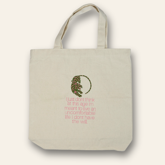 Embroidered canvas tote with a tiger design and humorous quote about comfort. Durable, reusable, and perfect for daily use.